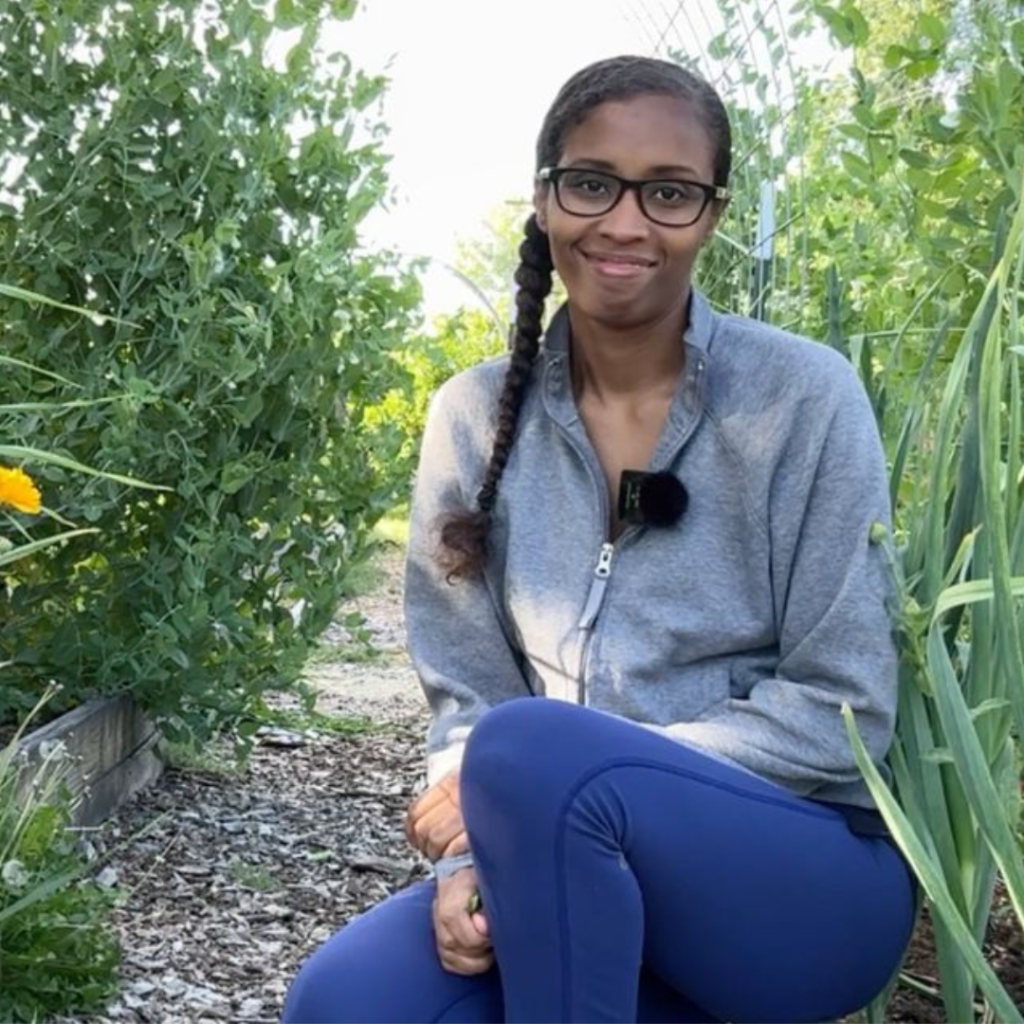 woman sitting in raised bed backyard garden