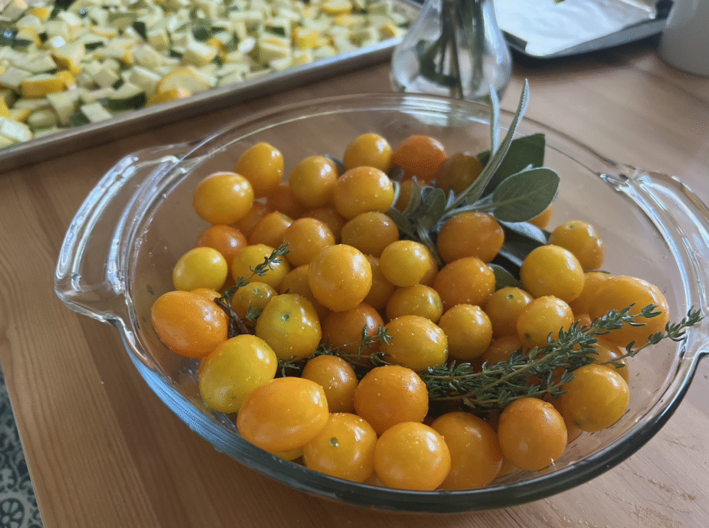 Tomato con fit with Golden Nugget tomatoes, sage, and rosemary in glass dish.